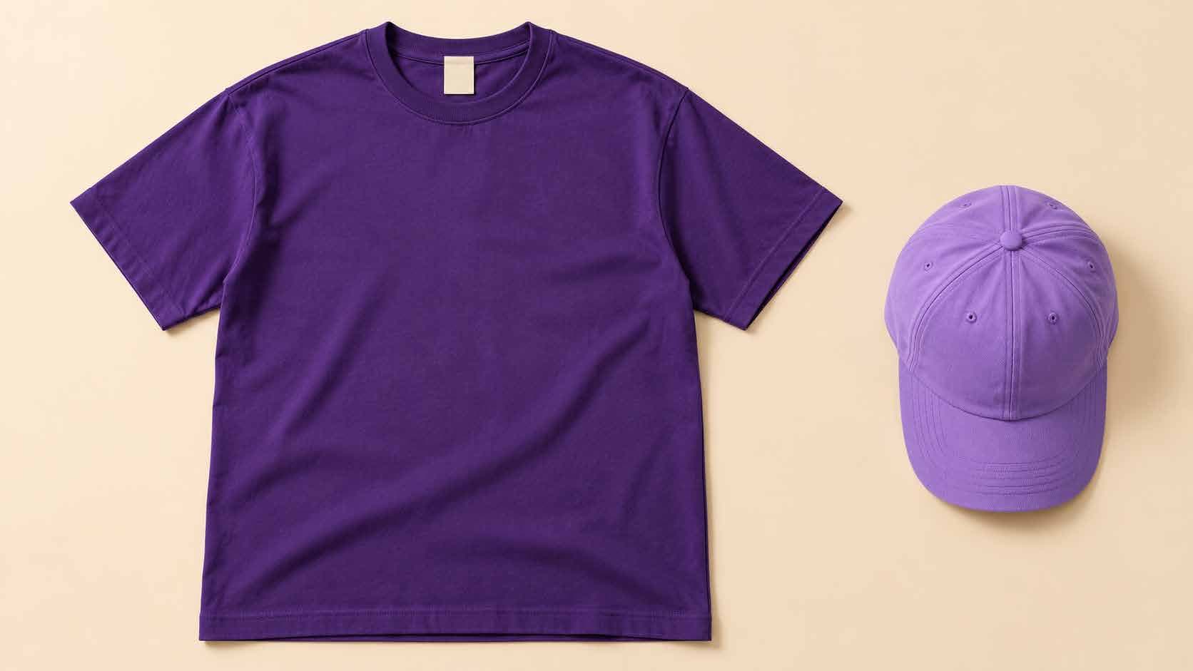 Concept purple t-shirt and cap on a cream background